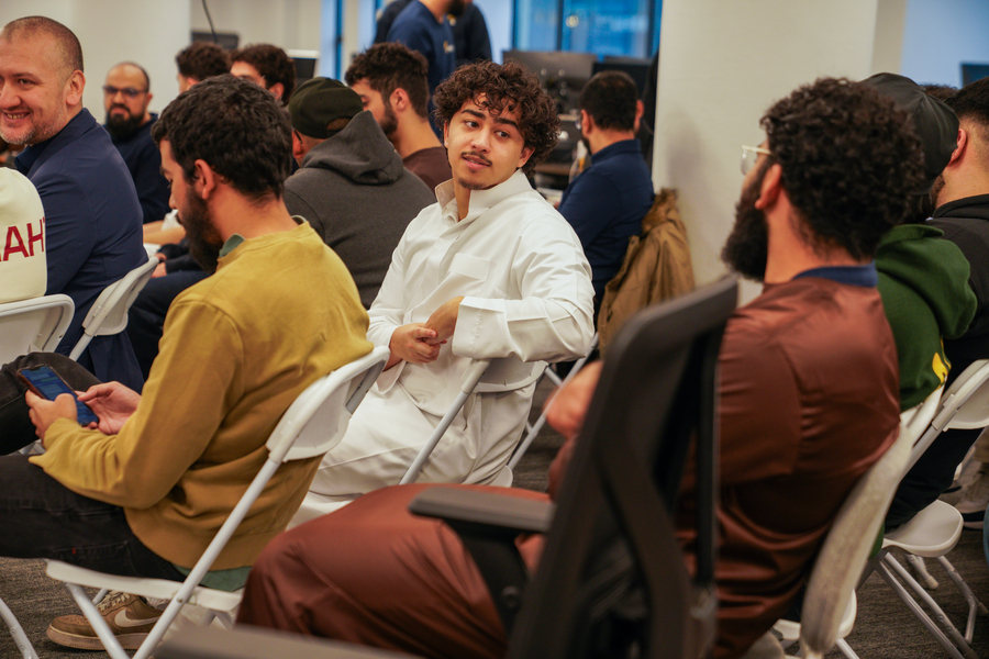 People sitting and listening as a speaker gives a talk