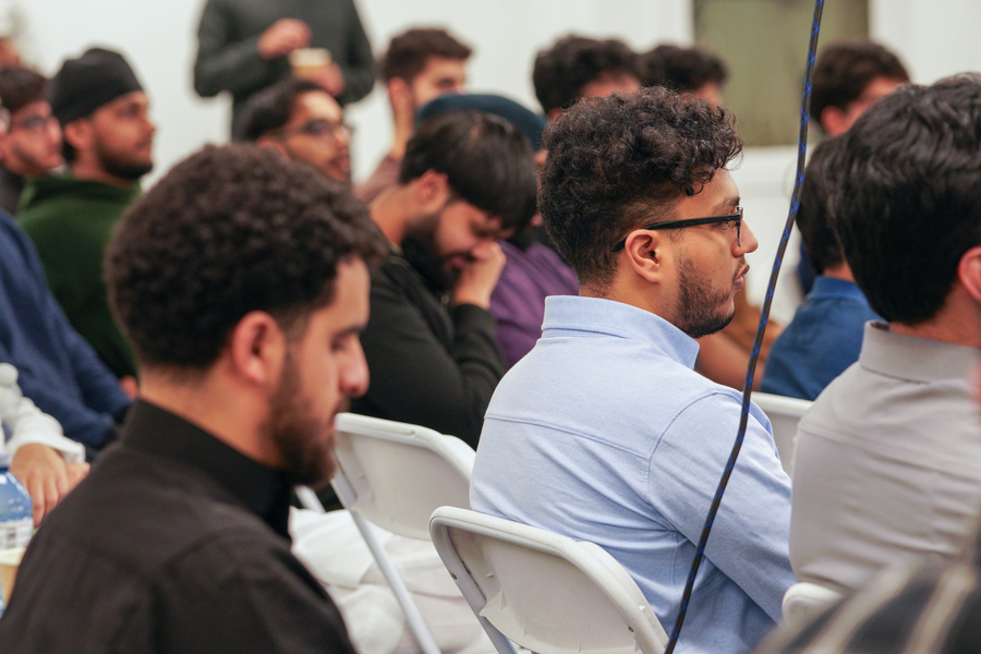 People sitting and listening as a speaker gives a talk