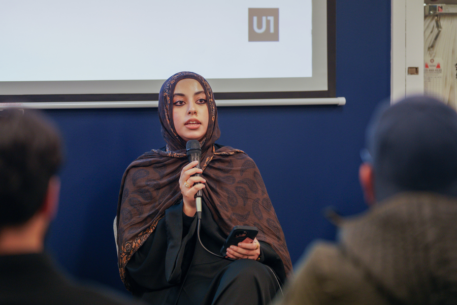 People sitting and listening as a speaker gives a talk