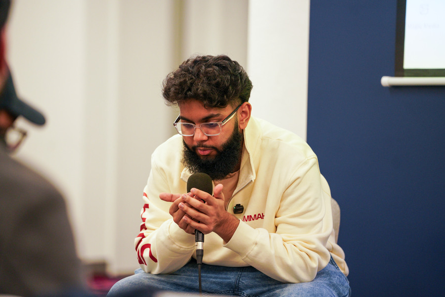People sitting and listening as a speaker makes a prayer