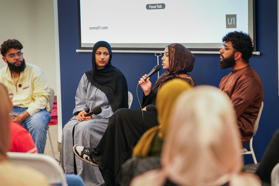 People sitting and listening as a speaker gives a talk